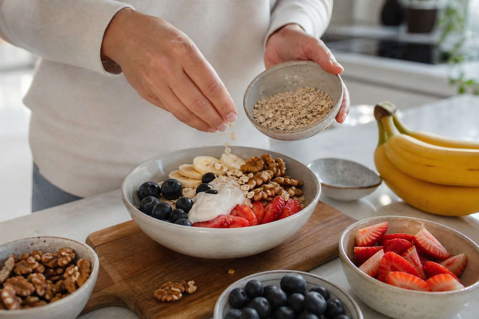 Preparación de un cuenco de fruta, yogur, frutos secos y avena